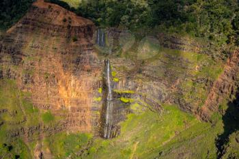 Aerial view of Waipo'o waterfall and landscape of Waimea Canyon of Kauai from helicopter flight