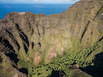 Aerial view of Na Pali coastline and landscape of hawaiian island of Kauai from helicopter flight