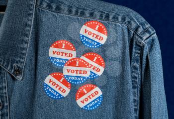 Multiple I Voted Today stickers on the blue denim working shirt collar for midterm elections in the USA
