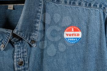 I Voted Today sticker on the blue denim working shirt collar for midterm elections in the USA