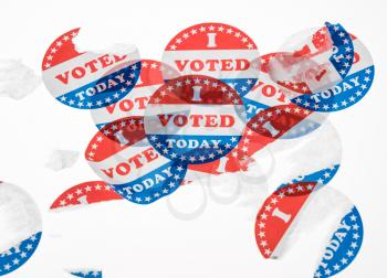 Torn and defaced I Voted Today stickers in aftermath of the US elections isolated on white background