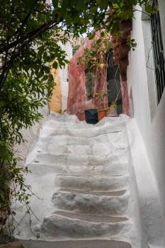 Narrow steps in ancient neighborhood of Anafiotika in Athens by the Acropolis