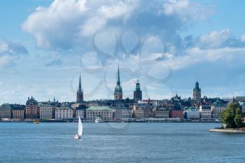 Panorama of Gamla Stan in Stockholm, Sweden with a yacht leaving the harbor