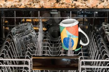 Cup and clear glass remain in dishwasher after a clean and rinse