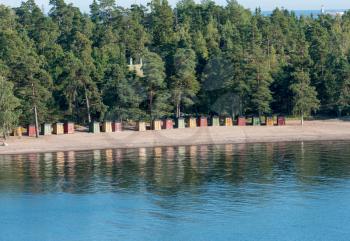 Collection of colorful beach huts on the beach on Pihlajasaari Island near Helsinki, Finland