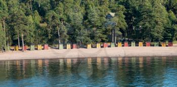 Collection of colorful beach huts on the beach on Pihlajasaari Island near Helsinki, Finland