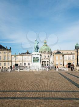 COPENHAGEN, DENMARK - SEPTEMBER 18: Tourists by Amalienborg Palace on September 18, 2017 in Copenhagen. The statue was built in 1760.