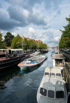 COPENHAGEN, DENMARK - SEPTEMBER 18: Canal Tour boat on Christianshavns Kanal on September 18, 2017. The company carries 800,000 people a year.
