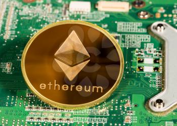 Ethereum or ether coin on a computer board to illustrate blockchain and cyber currency