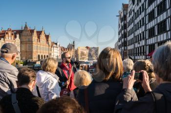 GDANSK, POLAND - 16 SEPTEMBER: Tourists visiting the old town on 16 September 2017 in Gdansk, Poland. The main buildings were rebuilt after the 2nd World War.