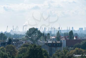 Smog and pollution over shipbuilding cranes of Gdansk in Poland