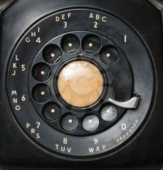Macro close-up of old and worn rotary dial on an old antique telephone