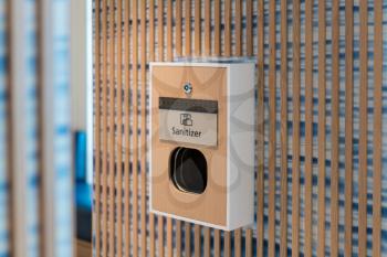 Machine for sanitizing hands outside a public bathroom or washroom in hotel