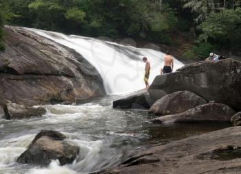 CASHIERS, NORTH CAROLINA - AUGUST 21, 2016: Three boys planning to swim in Turtleback Falls in Gorges State Park near Cashiers