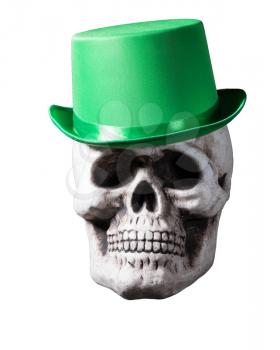 Skull with unusual green hat on its head and isolated against white background
