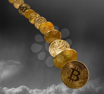 Bitcoin coins falling from the sky to illustrate the falling price of the cybercurrency