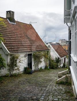Narrow street with cobblestones and wooden houses in old town Stavanger in Norway