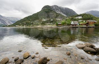 Small town of Eidfjord in Norway with clear waters of the fjord
