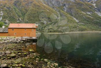 Brown wooden house with crane in Eidfjord in Norway