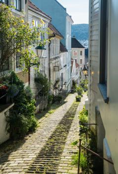 Narrow cobbestone Trangesmauet street in the old town of Bergen in Norway