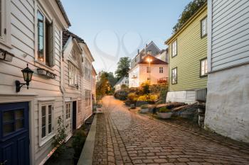 Narrow cobbestone Nedre Strangehagen Street at dusk in the old town of Bergen in Norway