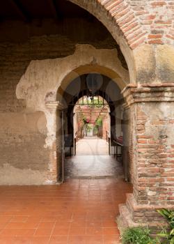 Arches through garden of the Mission at San Juan Capistrano, California