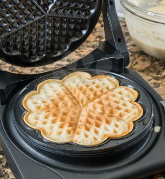 Norwegian heart shaped waffle maker on granite kitchen worktop
