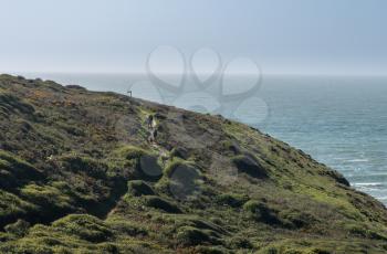 Hikers on coastline near Hartland Quay on North coast of Devon