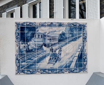 FUNCHAL, MADIERA - MARCH 12, 2018: Tiles illustrating Carro do Monte basket sled ride in Funchal on island of Madiera