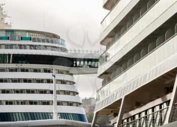 Balconies and cabins of two large cruise ships docked in Funchal Harbor in Madiera