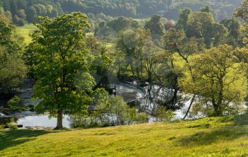 River Dee flows over the weir that feeds the Llangollen canal at Horseshoe falls on calm evening