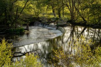 River Dee flows over the weir that feeds the Llangollen canal at Horseshoe falls on calm evening
