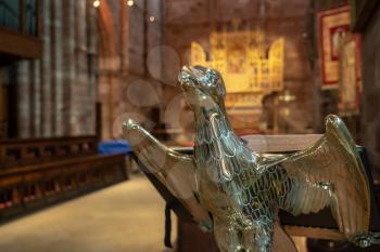 Interior and altar of Shrewsbury Abbey in Shropshire with a focus on the brass eagle bible stand