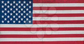 US Stars and Stripes flag painted onto a large wooden billboard