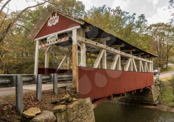 Narrow red painted Burkholder covered bridge near Garrett Pennsylvania
