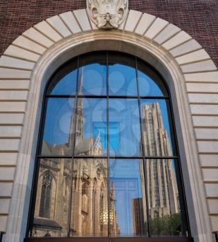 PITTSBURGH, PA - 4 JULY 2018: Reflection of Cathedral of Learning and Heinz Chapel in Pittsburgh PA