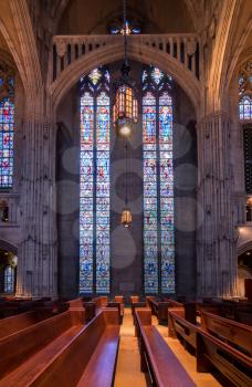 PITTSBURGH, PA - 5 JULY 2018: Tall high stained glass windows inside Heinz Chapel at the University of Pittsburgh PA
