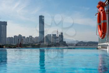 Panorama of the city skyline of Xiamen in China from swimming pool on cruise ship