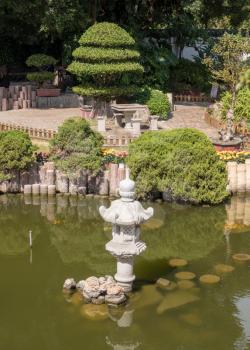 Ornamental Shuzhuang garden and pond with chinese lantern on island of Gulangyu near Xiamen