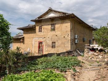 Tea plantations around stone home by Tulou at Unesco heritage site near Xiamen