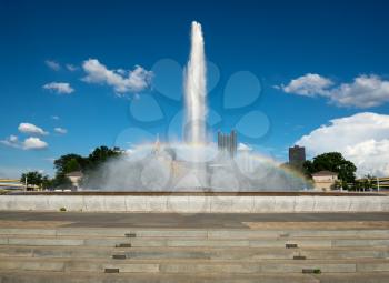 Soaring fountain at Point State Park frames the city skyline of downtown Pittsburgh PA