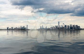 Panorama of Manhattan in NYC and Jersey City with artificial water showing reflections