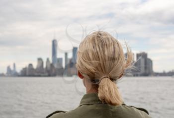 Back view of tourist on Staten Island Ferry approaching Manhattan