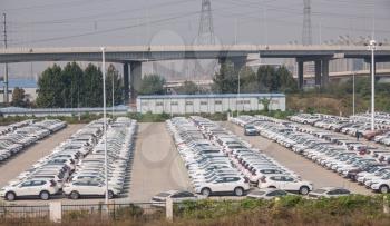 Thousands of new white chinese cars ready for delivery in ZhengZhouDong in China
