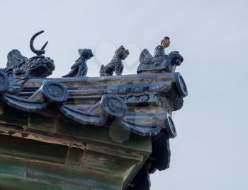 Ornate pottery tiles and carvings on roof of Temple of Heaven in Beijing, China