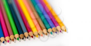 Row of colorful childs school drawing pencils against a white background
