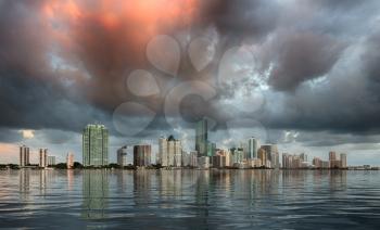 Miami cityscape skyline at sunrise on cloudy morning with an artificial sea illustrating flooding concept
