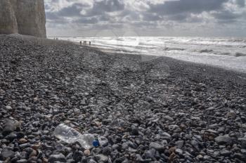 Plastic bottles blown onto the beach on stormy day at Birling Gap near Eastbourne