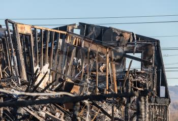 Charred and blackened remains of an office building destroyed by a fire