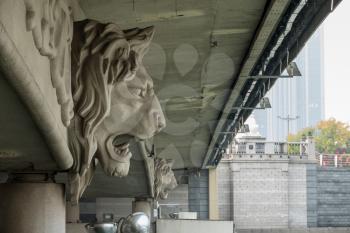 Detail of lion head carving under bridge in downtown Tianjin, China